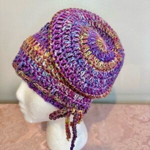 Handcrafted crochet slouchy beanie hat in purple variegated yarn.